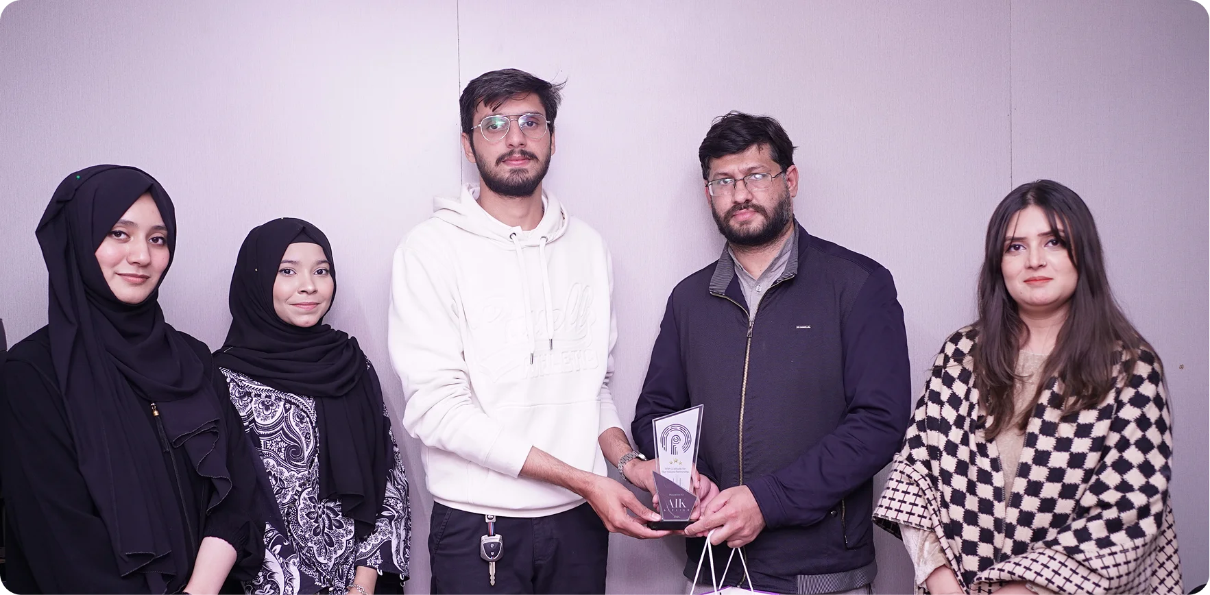 AIK Atelier HR team receiving shields and certifications as a ResourceInn HRMS client.