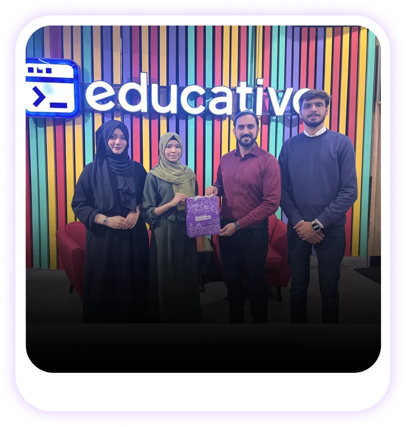 Group photo at an HR Lighthouse event featuring an Educative branded sign