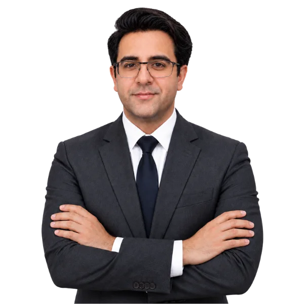 Hassan Masood Javaid, Chief People & Communications Officer, in a dark suit with arms crossed